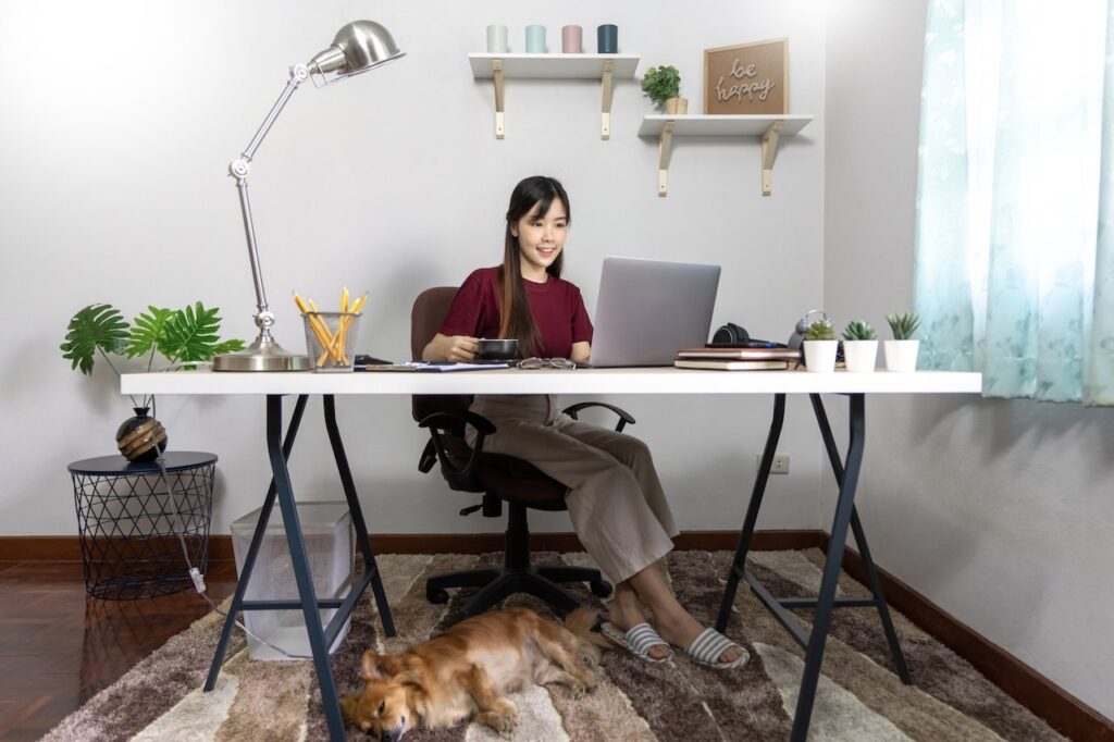 Woman attending a virtual social event in a home office.
